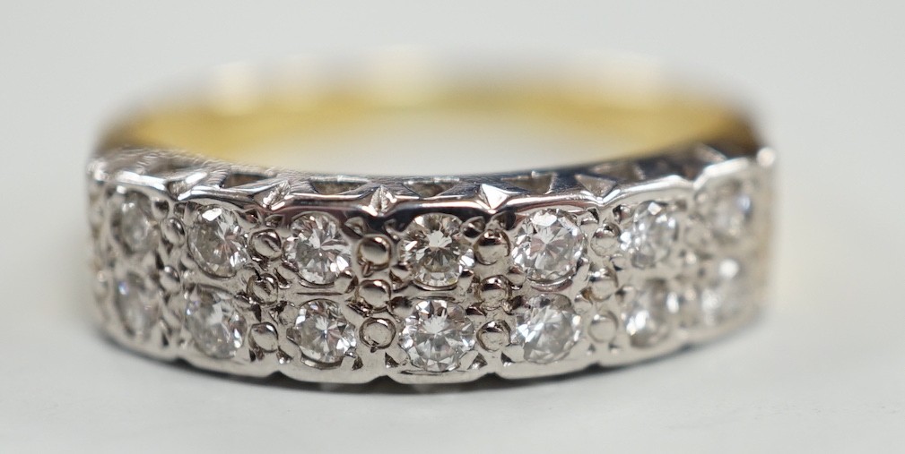 A modern 18ct gold and fourteen stone two row diamond set half hoop ring, size R/S, with textured shoulders, gross weight 5.4 grams.
